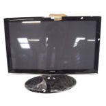 A Samsung plasma screen television and stand, with cables,