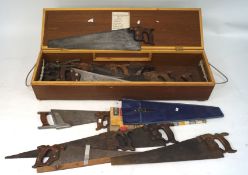 An assortment of vintage saws and other tools, of various sizes,