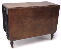 A 19th century mahogany drop leaf table, on turned supports with castors,