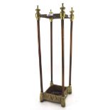 A 20th century metal stick/umbrella stand, with brass detailing,