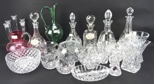 An assortment of glassware, including five decanters, a candlestick, salad bowl, green ewer,