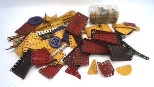 A large collection of Meccano, the pieces of various sizes, designs and colours,