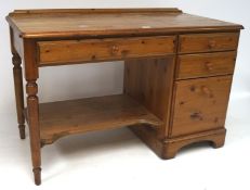 A 20th century pine desk, with three drawers to the right side and turned supports,