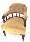 A late 19th/early 20th century armchair, upholstered in green fabric,
