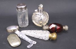 An assortment of glass bottles and collectables, including scent bottles, a silver pill box,