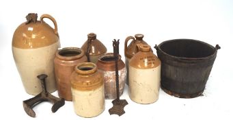 A large collection of stoneware flagons, of assorted sizes and designs,