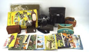 An assortment of collectables, including an Olympus OM-2 camera, a pair of Prinz 10x50 binoculars,