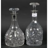 Two silver collared cut glass decanters, one hallmarked London 1928 by Mappin & Webb,