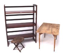 Two folding wooden tables and a display stand, the stand also containing two shelves,