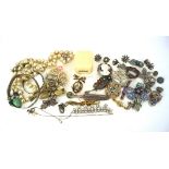 An assortment of costume jewellery, including a silver bangle, cameo brooch, filigree brooches,