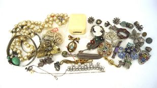 An assortment of costume jewellery, including a silver bangle, cameo brooch, filigree brooches,