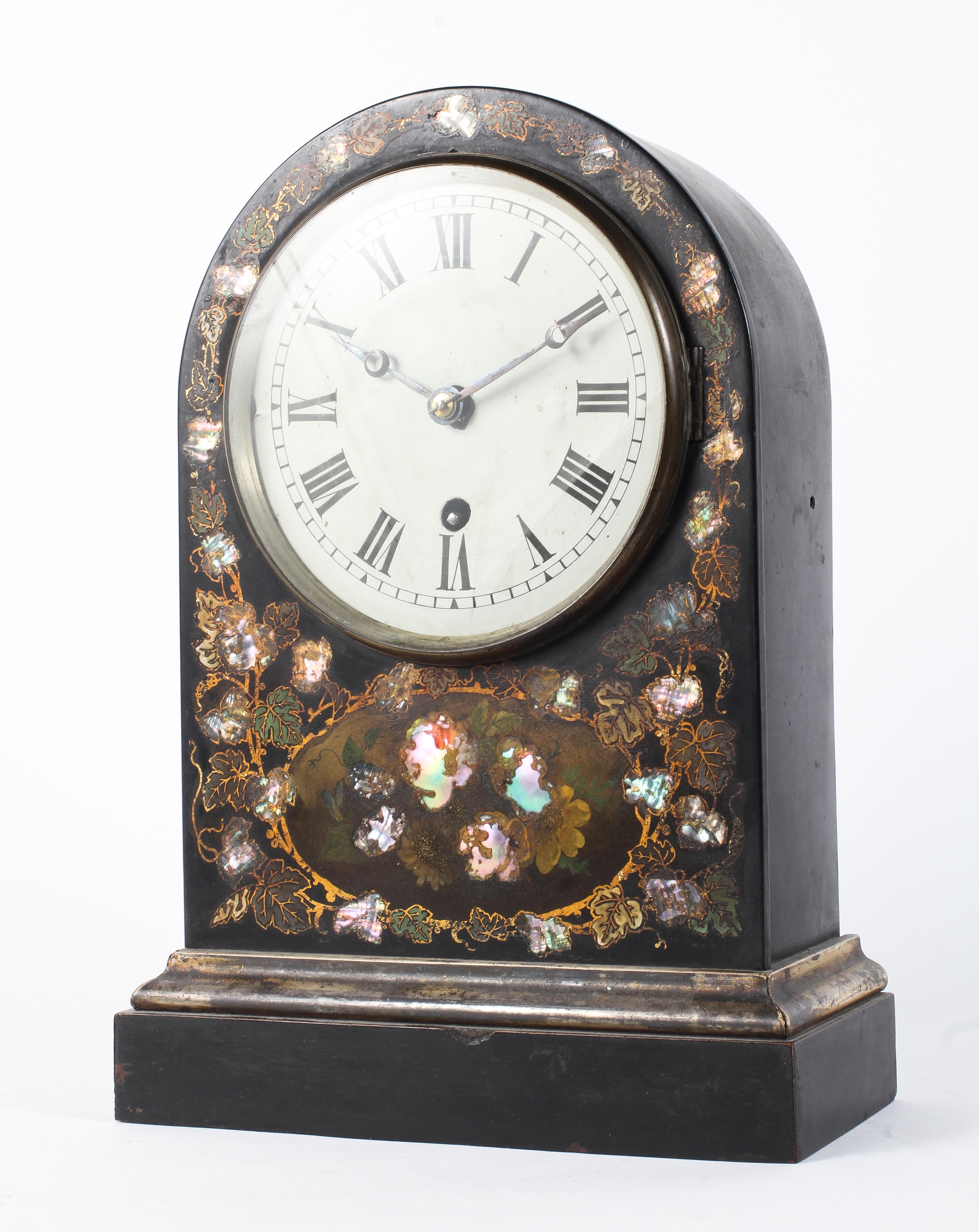 A Victorian japanned and mother of pearl inlaid mantel clock, of arched rectangular form,