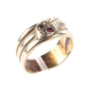 A 9ct yellow gold ring in the form of a snake, the eyes set with gems, ring size P/Q,