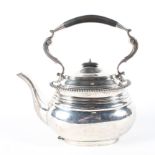 A silver tea pot, with gadrooned decoration and ebony handle and finial,