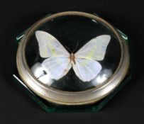 A 20th century white metal mounted desktop paperweight inset with a butterfly to centre,