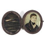 A Georgian portrait miniature of a gentleman on ivory, of oval form, in brown leather,