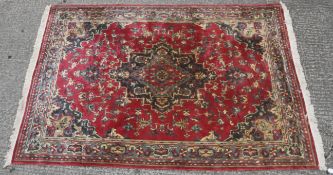 A 20th century wool rug woven in the Persian style,