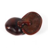 A 19th century wood netsuke of softly carved two mushrooms lying cap on cap,