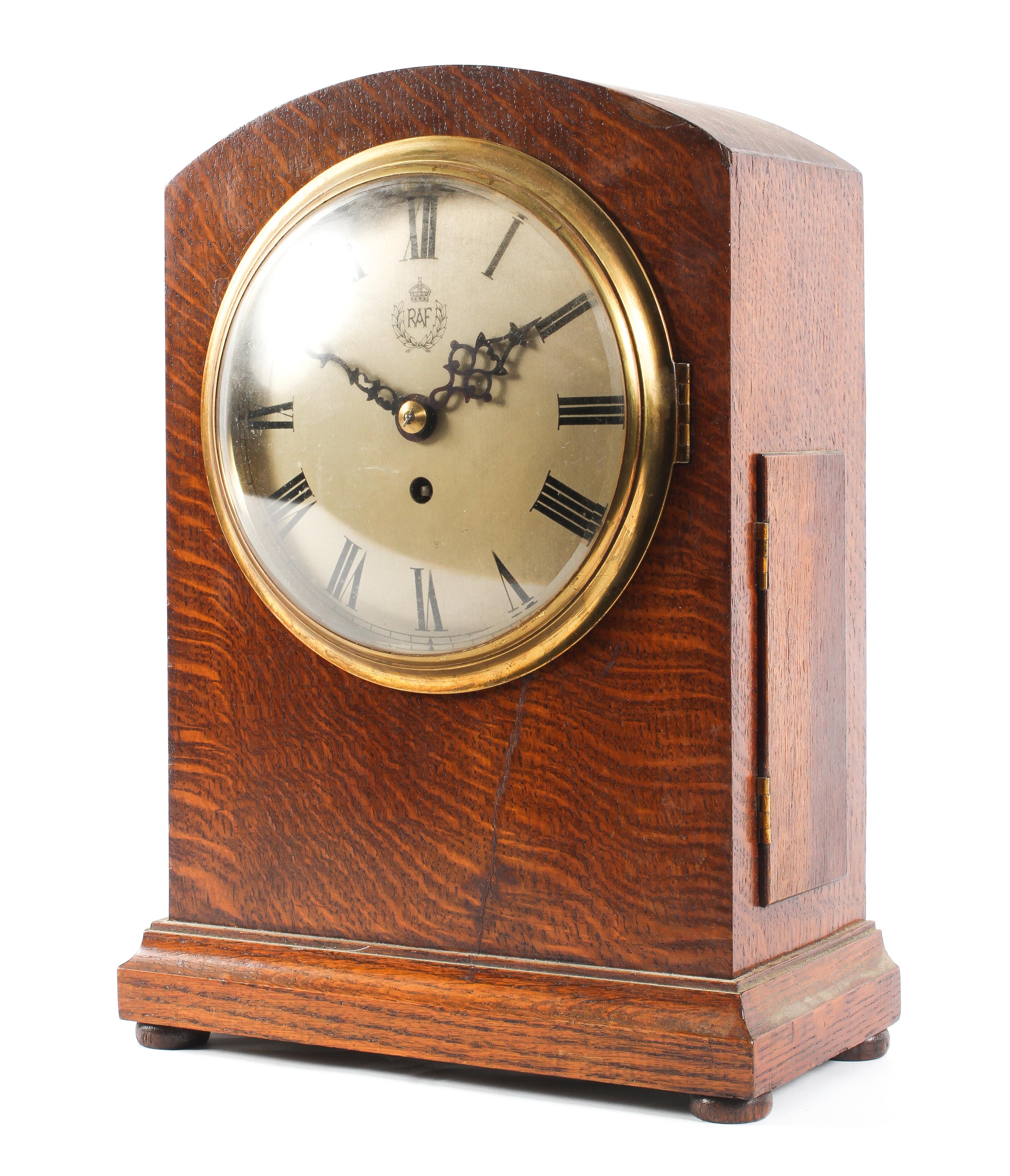 A World War II era oak cased RAF fusee mantel clock, of arched rectangular form,