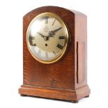 A World War II era oak cased RAF fusee mantel clock, of arched rectangular form,