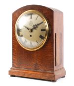 A World War II era oak cased RAF fusee mantel clock, of arched rectangular form,