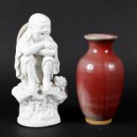 A Chinese blanc de chine figure and a sang de boeuf vase, 20th century,