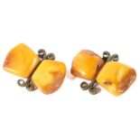 A pair of amber cufflinks, each with wire work decoration,