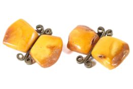 A pair of amber cufflinks, each with wire work decoration,