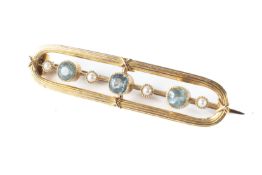 A gold (hallmark rubbed) possibly 14ct gold bar brooch set with aquamarine and seed pearls 3 grams
