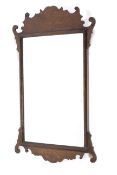 A Georgian style walnut pier mirror, with scrolling foliate cresting and mantling,