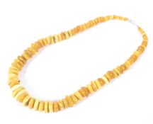 A single strand of honey/yellow graduated beads,