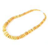 A single strand of honey/yellow graduated beads,