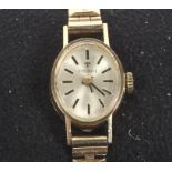 A 9ct gold cased ladies manual wind Tissot wristwatch, the silvered dial with baton hour markers,