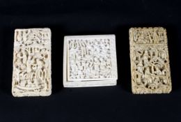 A late 19th century carved ivory box with puzzle and two card cases,