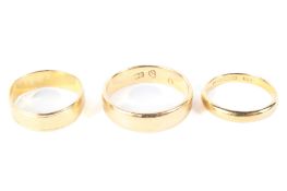 Two 22ct gold wedding bands 11 grams and a yellow metal ring 4 grams (possibly unmarked gold)