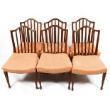 A set of six Edwardian mahogany arch backed dining chairs with square spindle backs