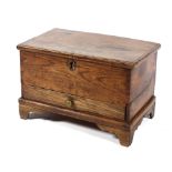 An 18th century small elm coffer or table top chest, with mouled hinged top above a drawer,