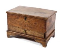 An 18th century small elm coffer or table top chest, with mouled hinged top above a drawer,