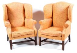 A matched pair of Georgian style wing back arm chairs,