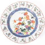 A large Chinese charger with foliate border decorated with birds beneath a flowering tree within