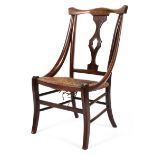 An Edwardian mahogany rush seated bedroom chair with shaped splat,