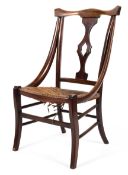 An Edwardian mahogany rush seated bedroom chair with shaped splat,