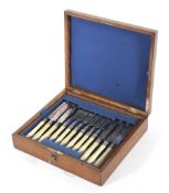 An Edwardian oak cased canteen with silver plated and ivory mounted flatware,