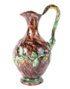 A late 19th century Portuguese Paliisy Ware ewer, with branch moulded handle,