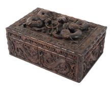 A Chinese carved wooden box, late 19th - early 20th century, carved with dragons and C-scrolls,