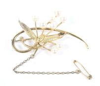 A yellow metal and pearl brooch, marked 14k, with safety chain, 6.