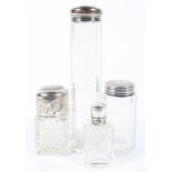 Three assorted silver topped dressing table jars and a scent bottle,
