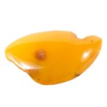 A polished Amber brooch of unusual form,