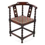 A late 19th century oak corner chair, with pierced heart shaped back and barley twist supports,