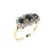 An 18ct gold and sapphire dress ring the central sapphire flanked by two smaller